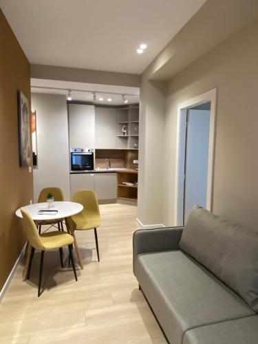 a living room with a couch and a table at Meri Apartment in Tirana
