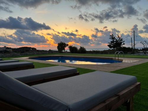 a swimming pool with a sunset in the background at Panorama in Elafonisi