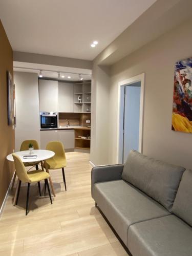 a living room with a couch and a table at Meri Apartment in Tirana