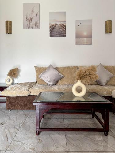 a living room with a couch and a coffee table at Delta Sharm 1 bedroom with Pool View in Sharm El Sheikh