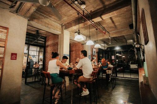 a group of people sitting at a table in a restaurant at The Bricks Hotel in Dumaguete
