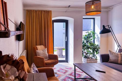 a living room with a couch and a table at Hotell Mossbylund in Abbekås