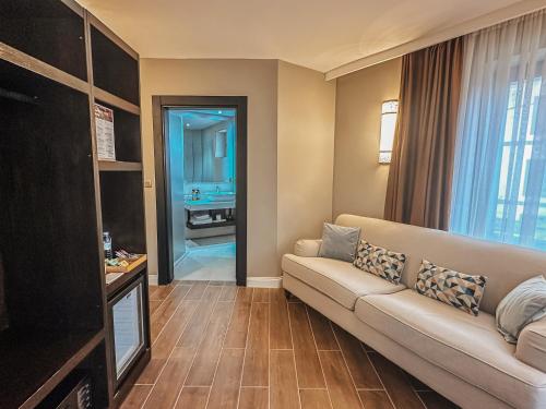 a living room with a couch and a television at Osmanli Cappadocia Hotel in Goreme