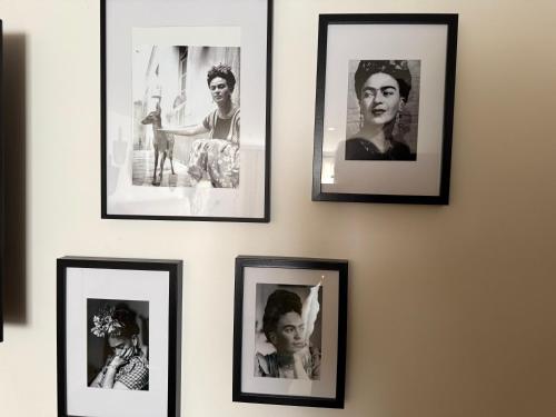 a group of black and white photographs on a wall at Origines in Tautavel