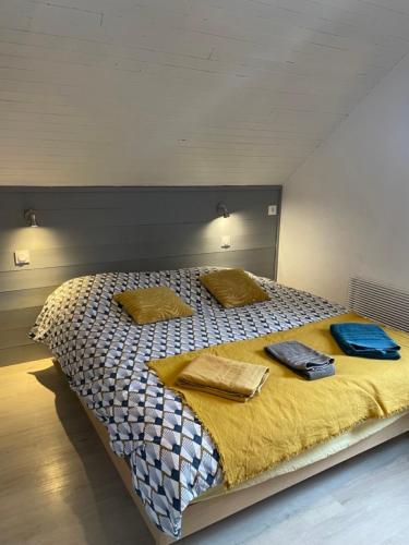 a large bed with two pillows on top of it at Maison L'Aiguille - 2 appartements, 5 chambres et table d'hôtes au pied de la montagne à la station de Laye in Laye