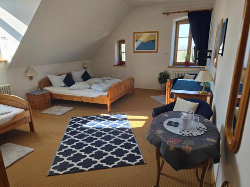 a living room with a bed and a table at Hotel Grenzenlos im Alten Gut in Würzburg