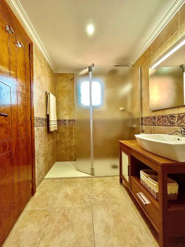 a bathroom with a sink and a shower at Casa Monte y Faro in Santa Pola