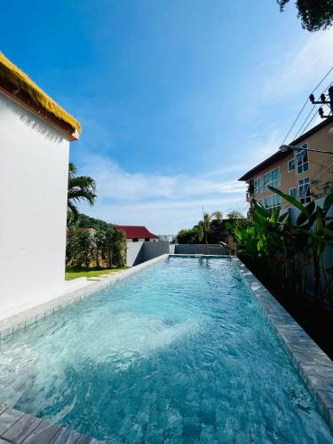 a swimming pool in the backyard of a house at Baan Saint-Tropez Seaview Villas Kata Beach in Kata Beach