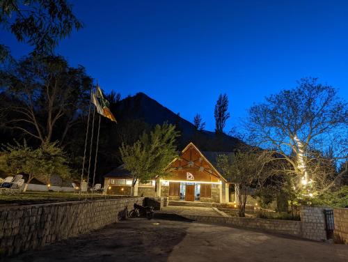 a house with a flag on top of it at night at Destination Hotel Khaplu in Khaplu