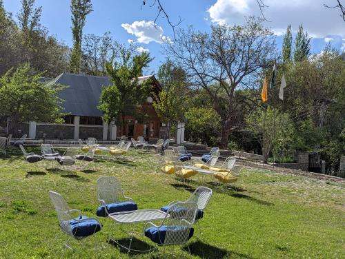 a group of chairs sitting in the grass at Destination Hotel Khaplu in Khaplu