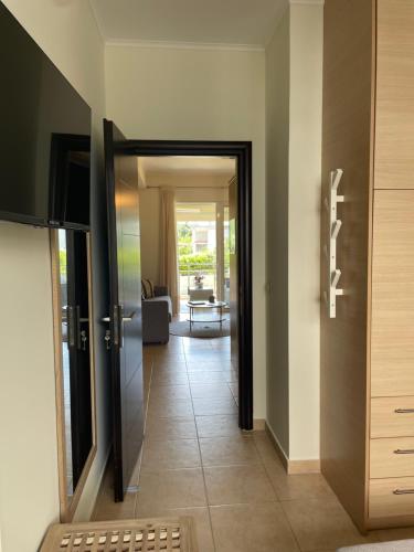 a hallway with a door leading to a living room at Xenia Serenity in Kalamata