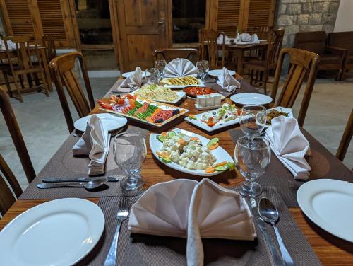 a table with plates and dishes of food on it at Destination Hotel Khaplu in Khaplu