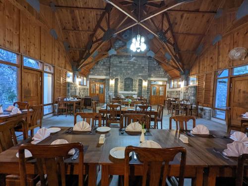 a large dining room with wooden tables and chairs at Destination Hotel Khaplu in Khaplu