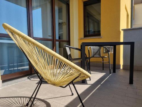 a chair on a patio with a table and chairs at Studio with terrace in Busto Arsizio