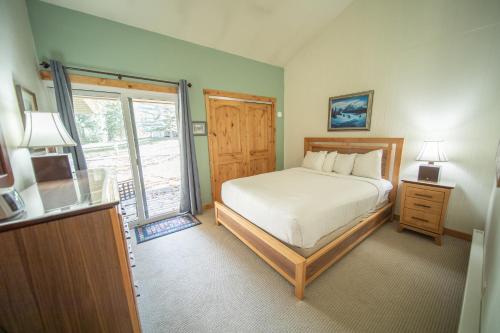 a bedroom with a bed and a large window at Flying Dutchman 1192 by SummitCove Lodging in Keystone