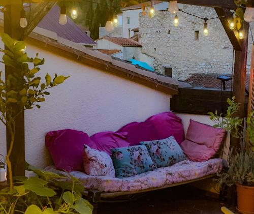 a couch sitting on a balcony with pillows at Origines in Tautavel