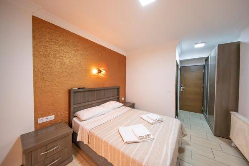 a bedroom with a bed with two towels on it at Marina Apart Hotel in Marmaris