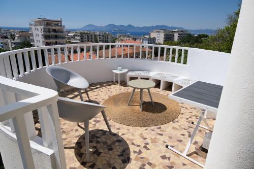 un balcon avec une table et des chaises sur un balcon dans l'établissement Sea view Luxury apartment pointe croisette, à Cannes