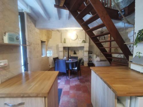 a kitchen and dining room with a table in a room at Maison Troglodyte in Saint-Léger-de-Montbrillais