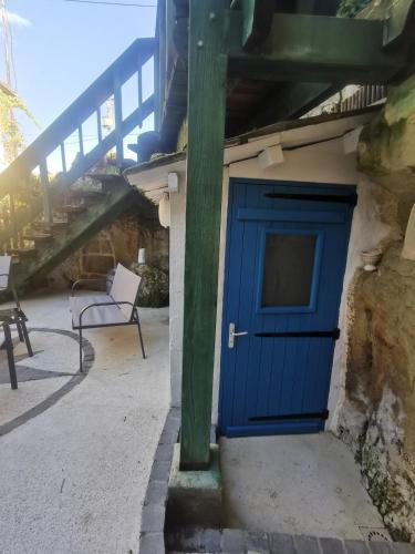 a blue door on the side of a building at Maison Troglodyte in Saint-Léger-de-Montbrillais