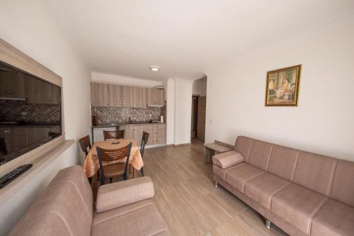 a living room with a couch and a table at Marina Apart Hotel in Marmaris