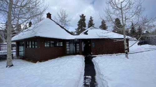 a house with snow on the roof of it at Soda Spring 1910 by SummitCove Lodging in Keystone