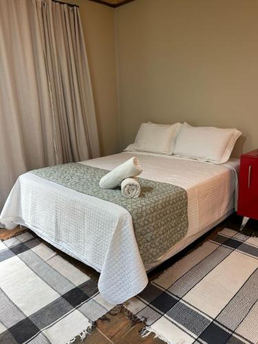 a bedroom with a bed with a towel on it at Terra Verde Visconde de Mauá in Visconde De Maua