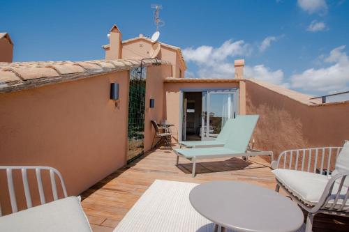 a patio with chairs and a table on a house at Gran Claustre Boutique Hotel in Altafulla