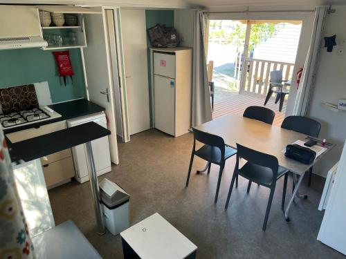 a kitchen and dining room with a table and chairs at Mobil'home à Torreilles Plage in Torreilles