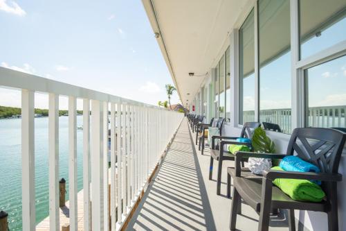 a row of chairs on a building overlooking the water at Gilbert's Resort in Key Largo