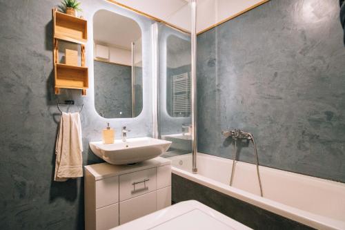 a bathroom with a sink and a mirror at Apartment Casa de Arena with a private parking space in Zagreb