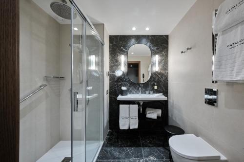 a bathroom with a shower and a toilet and a sink at Catalonia Plaza Catalunya in Barcelona