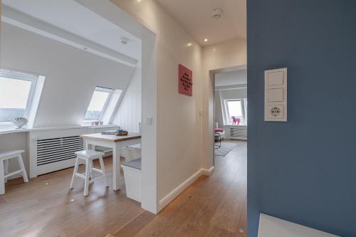 a white room with a table and a desk in it at Strönhof Kampen in Kampen