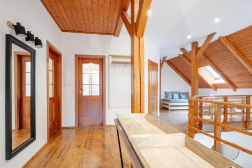 a living room with a staircase and wooden ceilings at Hotel Hvezda in Pec pod Sněžkou