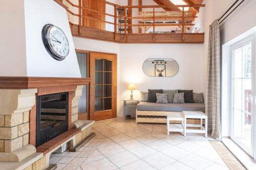 a living room with a fireplace and a couch at Hotel Hvezda in Pec pod Sněžkou