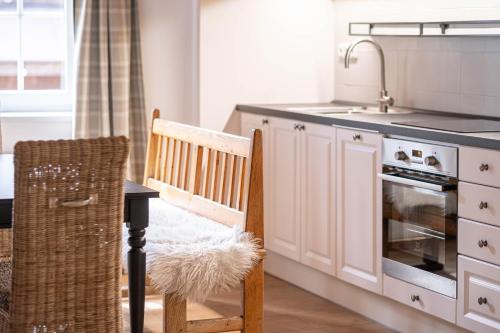 a kitchen with a sink and a table and a chair at Hotel Hvezda in Pec pod Sněžkou