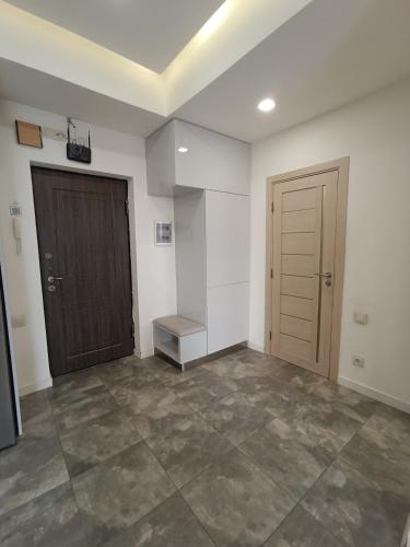 an empty room with a door and a staircase at Rent Inn Yerevan on Koghbaci Street in Yerevan