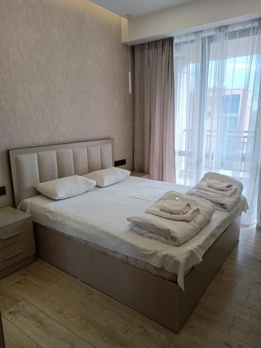 a bedroom with a large bed with towels on it at Rent Inn Yerevan on Koghbaci Street in Yerevan