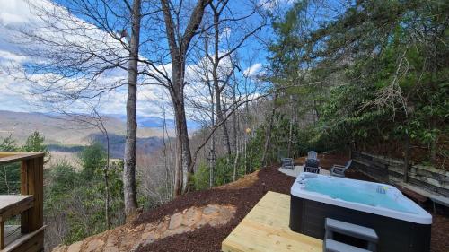 a hot tub on a table with a view of the mountains at SMOKY MOUNTAIN MAGIC-Spectacular Views, 3 Br, Sleeps 8, Hot Tub in Bryson City