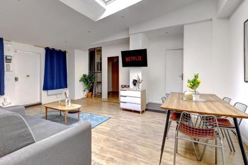 un salon avec un canapé et une table dans l'établissement Appartement elegant pour 6 pers au coeur de Paris, à Paris