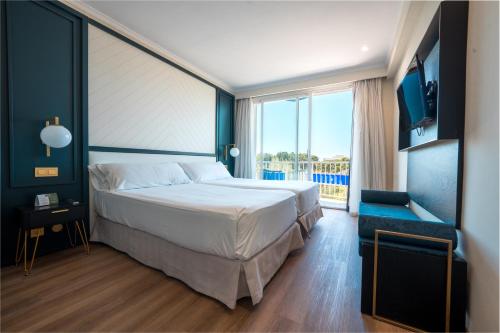 a bedroom with a large bed and a large window at NURA Boreal in Playa de Palma