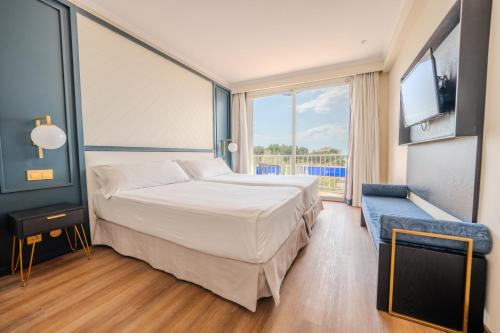 a hotel room with a bed and a large window at NURA Boreal in Playa de Palma