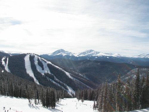 a group of people skiing down a snow covered mountain at Montezuma 1770 by SummitCove Lodging in Keystone