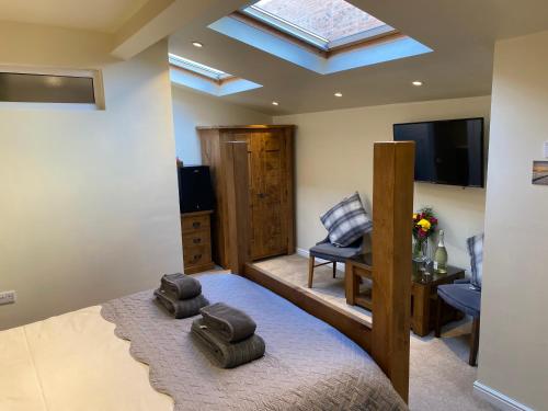 a bedroom with a bed with a skylight at The Whalebone Arch in Whitby
