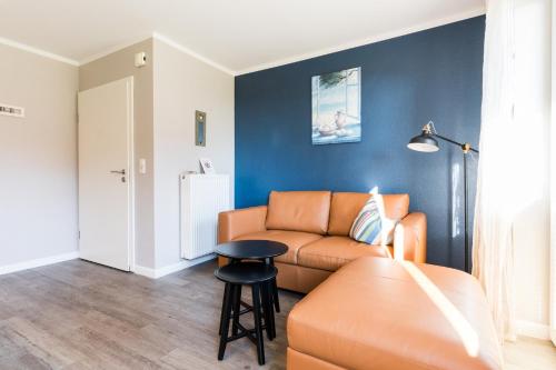 a living room with a couch and a table at Fehmarnstrand 78 App 9 in Staberdorf