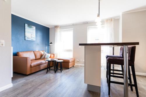 a living room with a couch and a table at Fehmarnstrand 78 App 9 in Staberdorf
