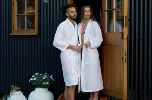a man and a woman standing in front of a house at Humphrey Hut in Southborough
