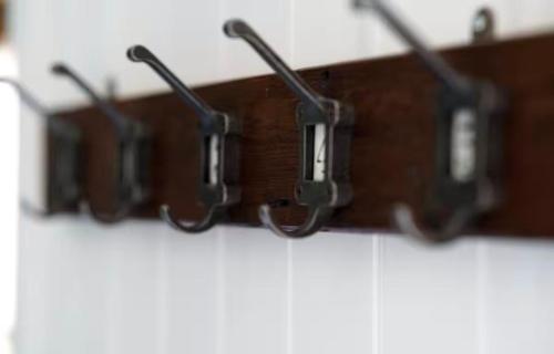 a row of glasses hanging on a wall at Humphrey Hut in Southborough