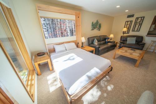a bedroom with a bed and a living room at Quicksilver 1616 by SummitCove Lodging in Keystone
