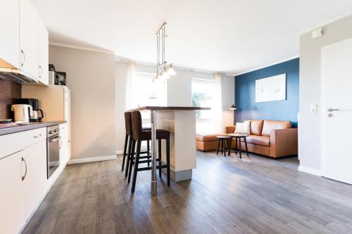a kitchen and living room with a table and chairs at Fehmarnstrand 78 App 10 in Staberdorf